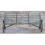 A Victorian iron strapwork three seat garden bench with distressed paintwork, H 80cm x W 180cm x D