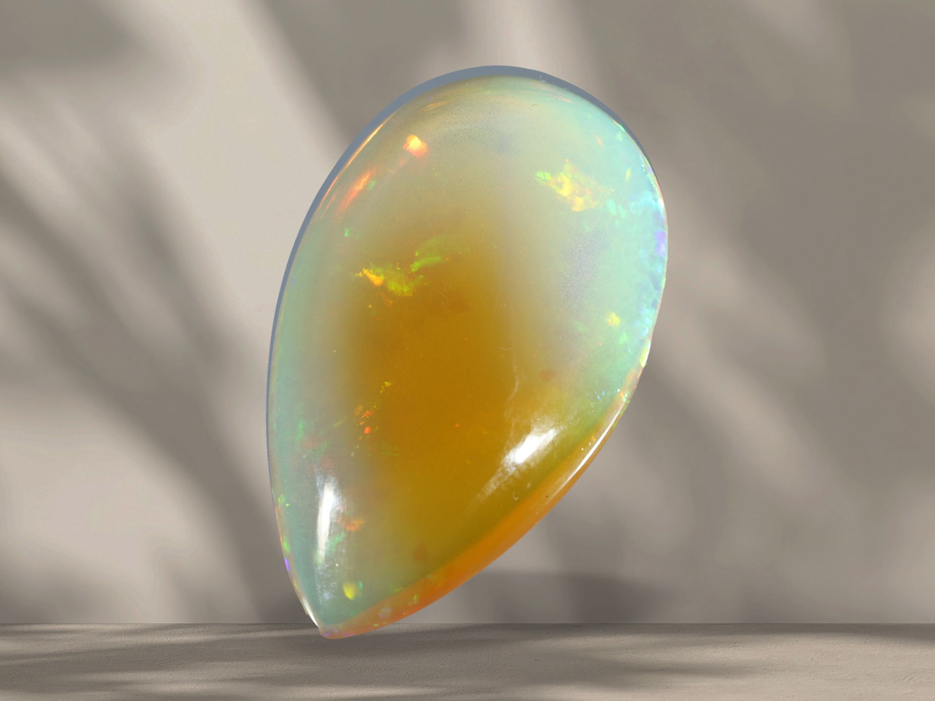 Opal of approx. 30ct in drop shape with interesting play of colours