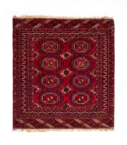 A RED HAND KNOTTED WOOL RUG FROM BOKHARA, UZBEKISTAN