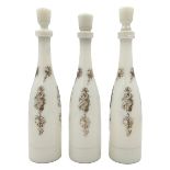 THREE WHITE OPALINE BOTTLES WITH STOPPERS