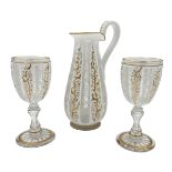 BOHEMIAN GLASS EWER AND CUPS WITH GILT HIGHLIGHTS