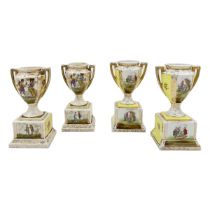 FOUR MINIATURE AUSTRIAN PORCELAIN VASES RAISED ON A SQUARE BASE