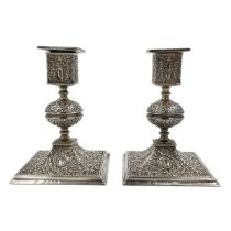 AN UNUSUAL PAIR OF SILVER ENGLISH HALLMARKED CANDLESTICKS DECORATED IN THE INDIAN STYLE, LONODN,1889