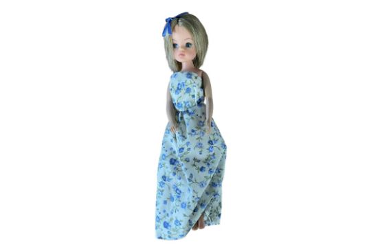 Second generation Sindy with short cropped hair in white and blue floral dress with blue hair bow,