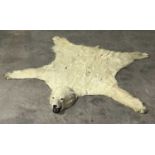 Taxidermy: Polar Bear Skin (Ursus maritimus), 20th century, adult skin rug with head mount, jaw