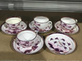 A set of four 19th Century Sunderland pink lustre tea cups and five saucers, bird on a branch