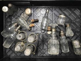 A collection of silver mounted glassware including scent bottles, condiment sets etc