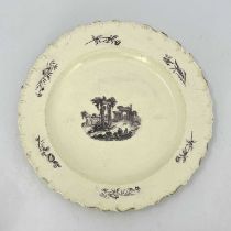 A large English creamware charger, 18th century, decorated with an image of Palmyra. 39 cm
