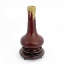 A Chinese sang de boeuf glazed pottery vase, bulbous form, hares fur ochre over red glaze, on a