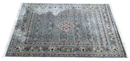 A large floral Persian rug, cream medallion on a pale blue field, 273 x 360 cm
