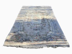 A very large Chinese wash rose rug, concentric foliate wreath decoration, central floral bouquet,