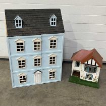 A vintage dollhouse with tinplate window frames, a large modern dollhouse and a small quantity of