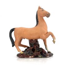 A Chinese porcelain figure, 19th century, modelled as a figure of a colt, with black mane and