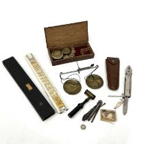 A set of Georgian hand-held scales, in a wooden box with circular flat weights, a 19th Century