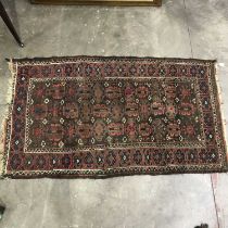 Two tribal rugs, one Baluch style, on red ground, 144 by 75cm and 142 by 92cm (2)