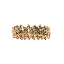 A late Victorian 9ct gold opal and ruby expanding bangle bracelet