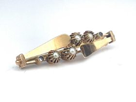 A gold and pearl modernist brooch