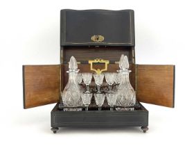 An Edwardian boxed cut glass liqueur set, the rosewood stand of thistle cut decanters and stemmed