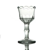 A pedestal sweetmeat glass, circa 1780, the ogee bowl with denticulated rim and slice cut lower