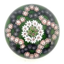 Clichy, a millefiori garland glass paperweight, the central rosette of multi cogged canes and
