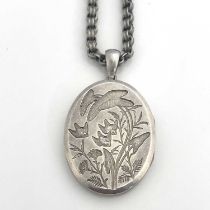 A Victorian Aesthetic Movement white metal locket on chain, incuse embossed with ferns and birds