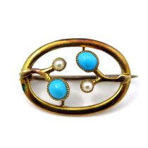 An Arts and Crafts 15 carat gold and turquoise brooch, oval form with stylised buds, in split