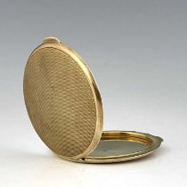 An Art Deco 9 carat gold compact, Goldsmiths and Silversmiths Company, London 1937, circular, engine