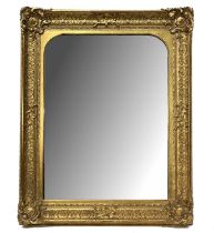 A large rectangular gilt framed wall mirror, late 19th Century, arched plate, fillet, Rococo