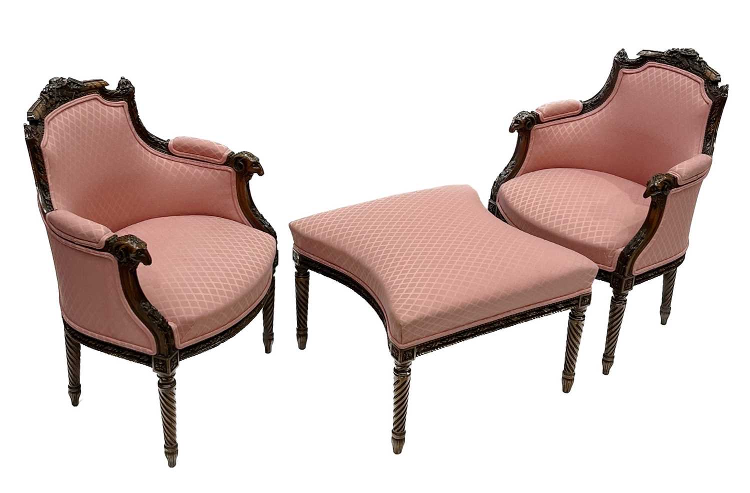 A pair of fauteuil and matching stool to form a chaise, of Louis XVI design, carved frames with rams