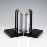A pair of Art Deco chrome and black glass bookends, circa 1930, the rectangular slabs fin grill