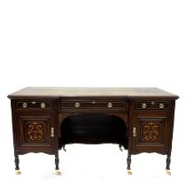 An Edwardian mahogany breakfront writing table, circa 1910, crossbanded and marquetry inlaid, triple