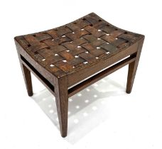 Arthur Simpson of Kendal, an Arts and Crafts carved oak and leather stool, rectangular section