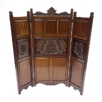 An Edwardian mahogany triptych screen, serpentine scroll top with carved shell pediment, the fielded