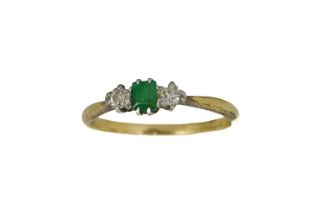 An 18ct gold, diamond and emerald ring, the central green stone flanked by two rose cut diamonds,