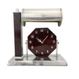 An Art Deco chrome and bakelite desk lamp clock, circa 1930, the octagonal face with applied