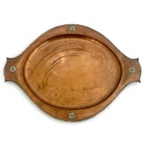 A E Jones, an Arts and Crafts copper and silver tray, circa 1920, planished twin handled oval form