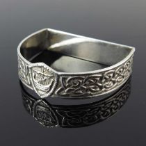 Alexander Ritchie, a Scottish Arts and Crafts Iona silver napkin ring, circa 1920, demilune form