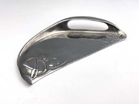 Archibald Knox for Liberty & Co, a Tudric pewter crumb scoop, circa 1905, half-moon form with