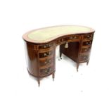 An Edwardian mahogany kidney-shaped pedestal writing desk in the manner of Edwards & Roberts,