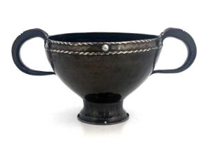 An Arts and Crafts copper and silver twin handled bowl, planished footed form with mixed metal