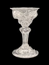 A diamond moulded sweetmeat glass, circa 1740, the double ogee bowl with optic diaper lattice, on