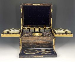 A Victorian fitted dressing case, of rounded rectangular form in brass bound coromandel, with