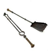 A pair of Gothic Revival brass and wrought steel fireside companion tools, including shovel and