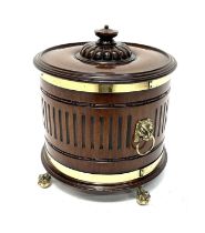 A late 19th Century cellarette, of drum form, turned cover with finial atop a gadroon craved dome,