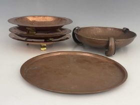 Birmingham Guild of Handicraft, four Arts and Crafts copper and brass dishes and trays, circular and