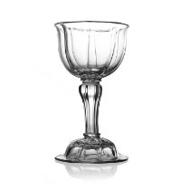 A pedestal sweetmeat glass, circa 1745, the vertically ribbed bell shaped bowl on a fluted inverse