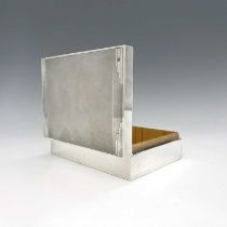 A George V silver Art Deco cigarette box, of rectangular form, the body decorated with engine-
