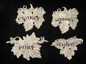 Four similar Victorian silver wine labels or bottle tickets, each die-stamped and of leaf form