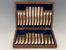 An early twentieth-century twelve-place dessert service, comprising twelve knives and twelve four-