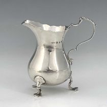 A Victorian silver cream jug, modelled in the George II style, of ogee form, with wavy edge rim, S